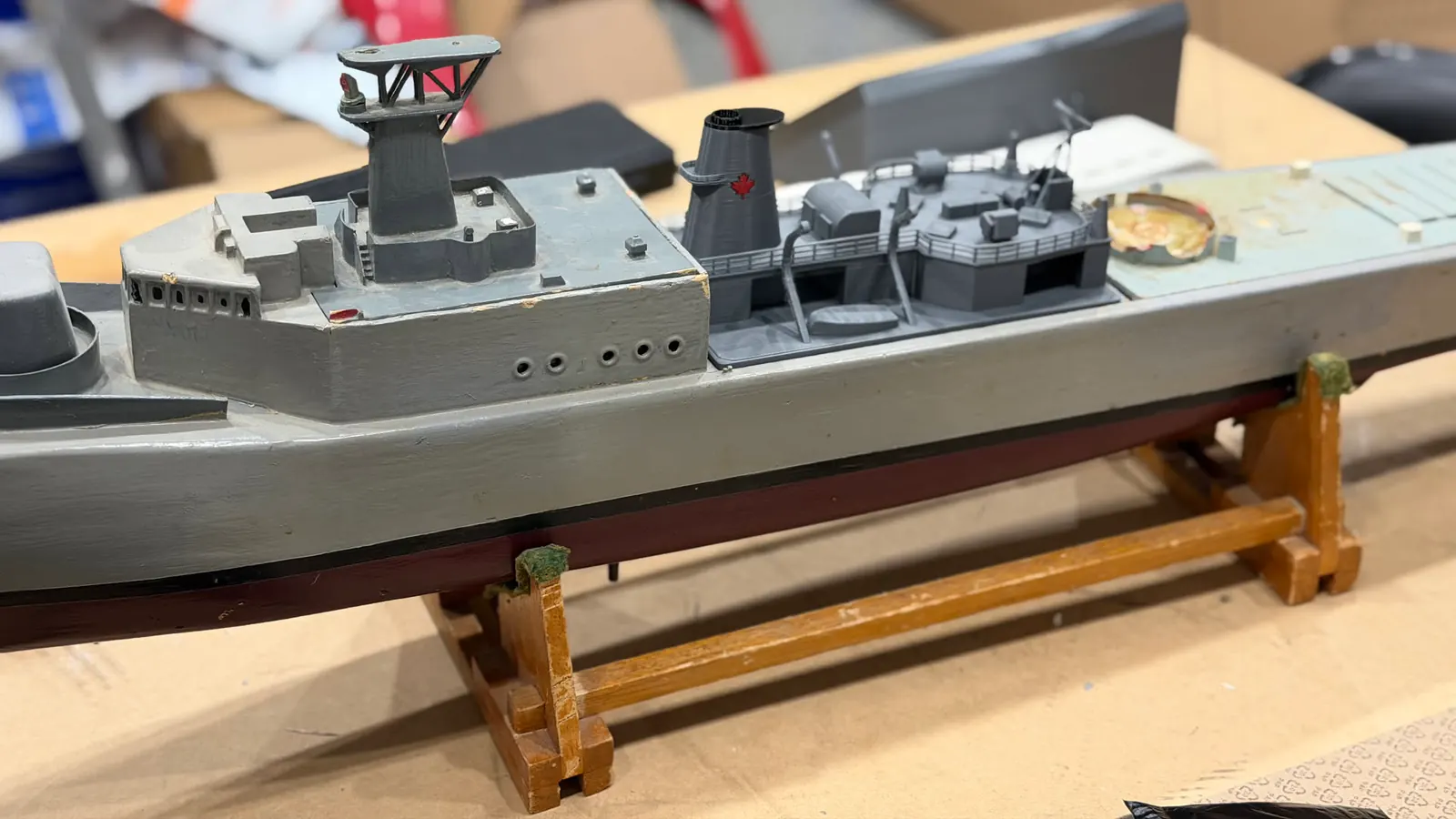 Grey RC model warship on a wooden stand, fitted with a new printed superstructure and funnel