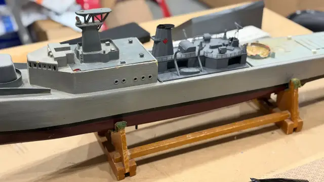 Grey RC model warship on a wooden stand, fitted with a new printed superstructure and funnel